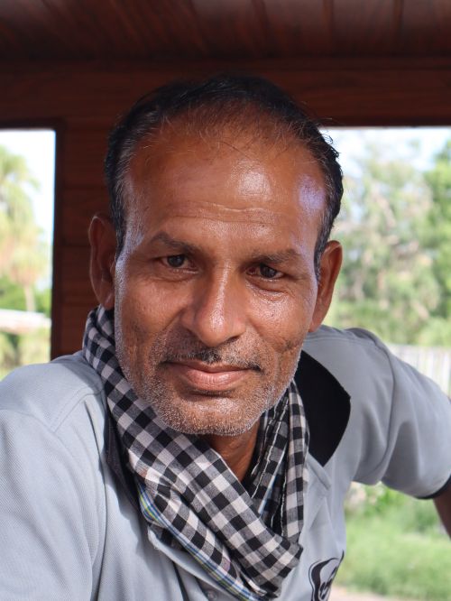 Free Close-up portrait of an adult man with a checkered scarf, captured outdoors with natural light. Stock Photo