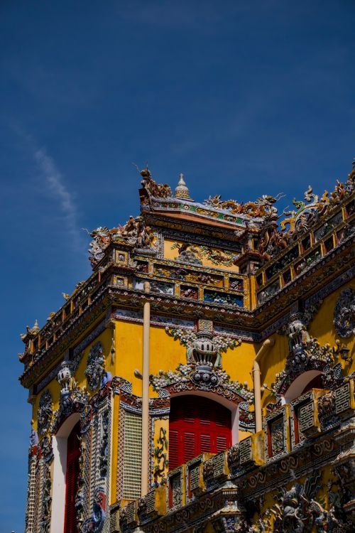 Free A beautifully ornate temple facade with intricate designs, vibrant colors, and a clear blue sky. Stock Photo
