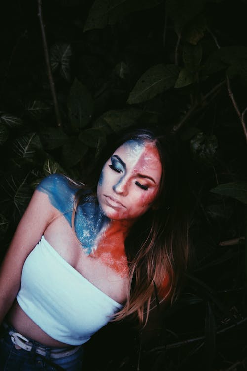 Calm woman with red and blue paint on face