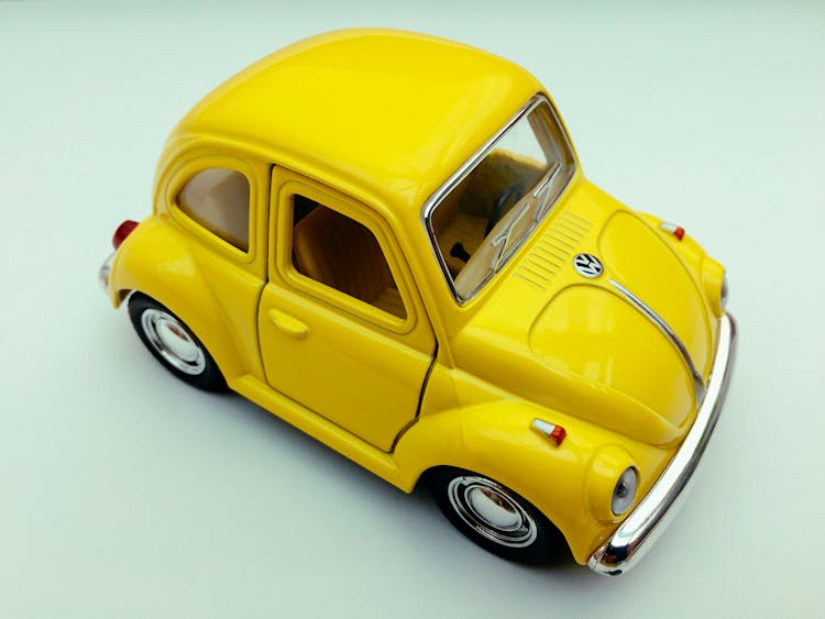 Yellow Volkswagen Beetle Toy Car On White Background