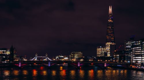 Free Captivating night view of The Shard and Tower Bridge reflecting on the River Thames in London. Stock Photo