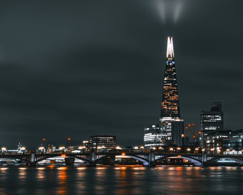 Free Captivating night view of The Shard skyscraper in London, towering over the Thames. Stock Photo