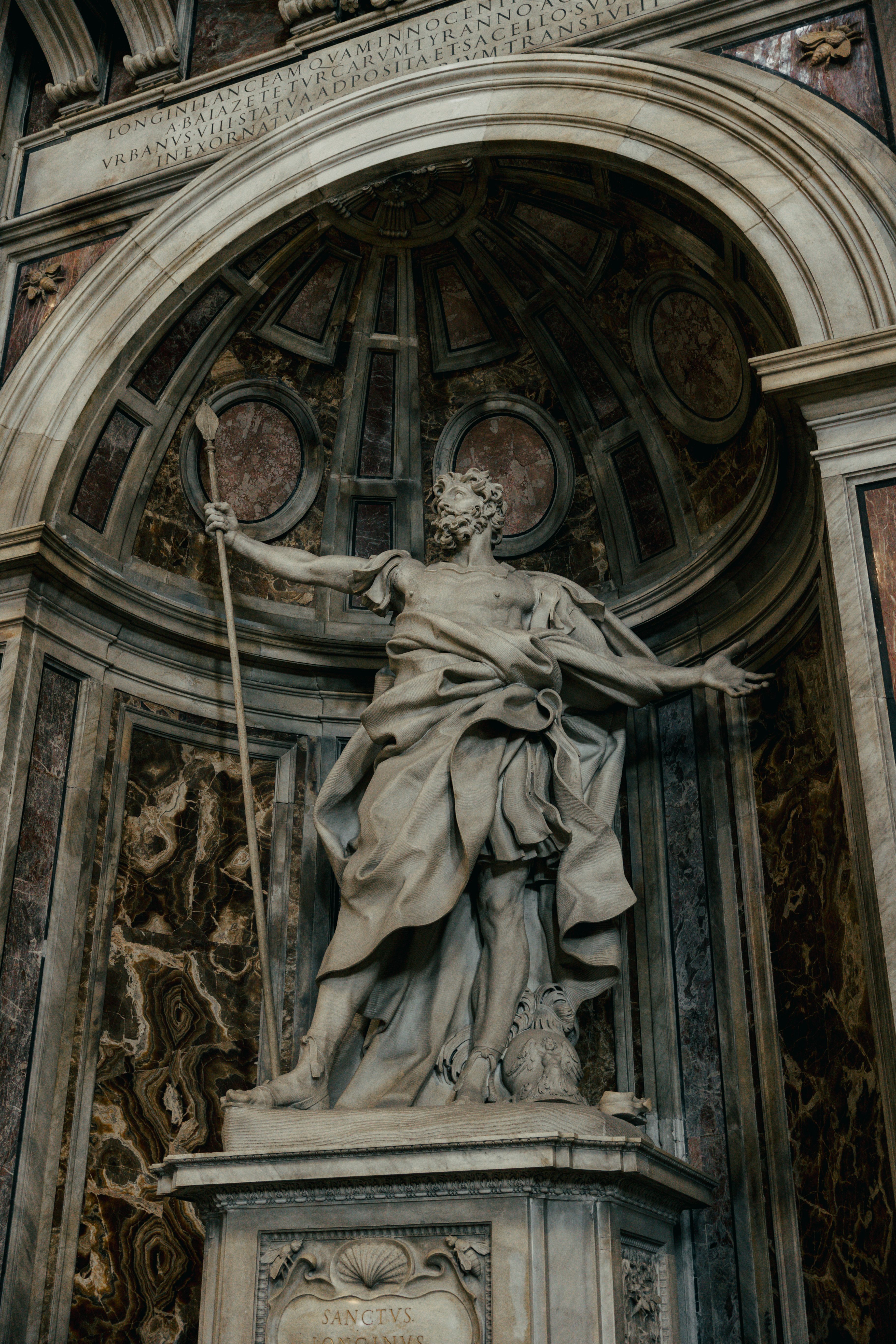 Detailed view of a Renaissance marble statue inside a basilica in Rome, capturing classical artistry and grandeur.