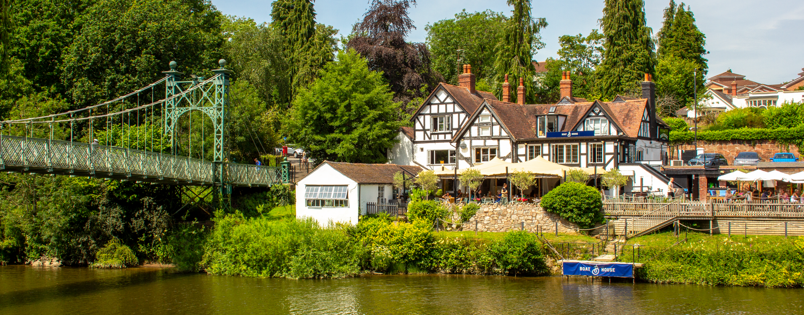Beautiful summer view of the River Severn with a historic bridge in Shrewsbury, UK.