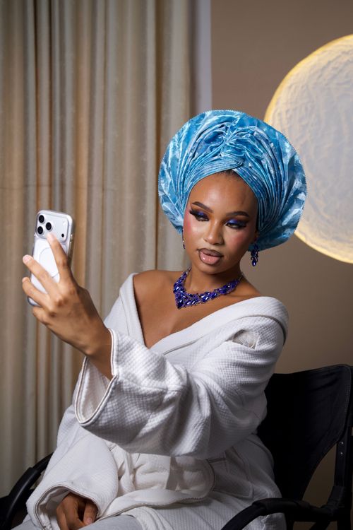 Free A striking studio portrait of a woman in traditional attire taking a selfie. Stock Photo