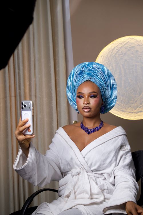 Free Studio portrait of a woman in traditional headwrap, vibrant makeup, and elegant robe. Stock Photo