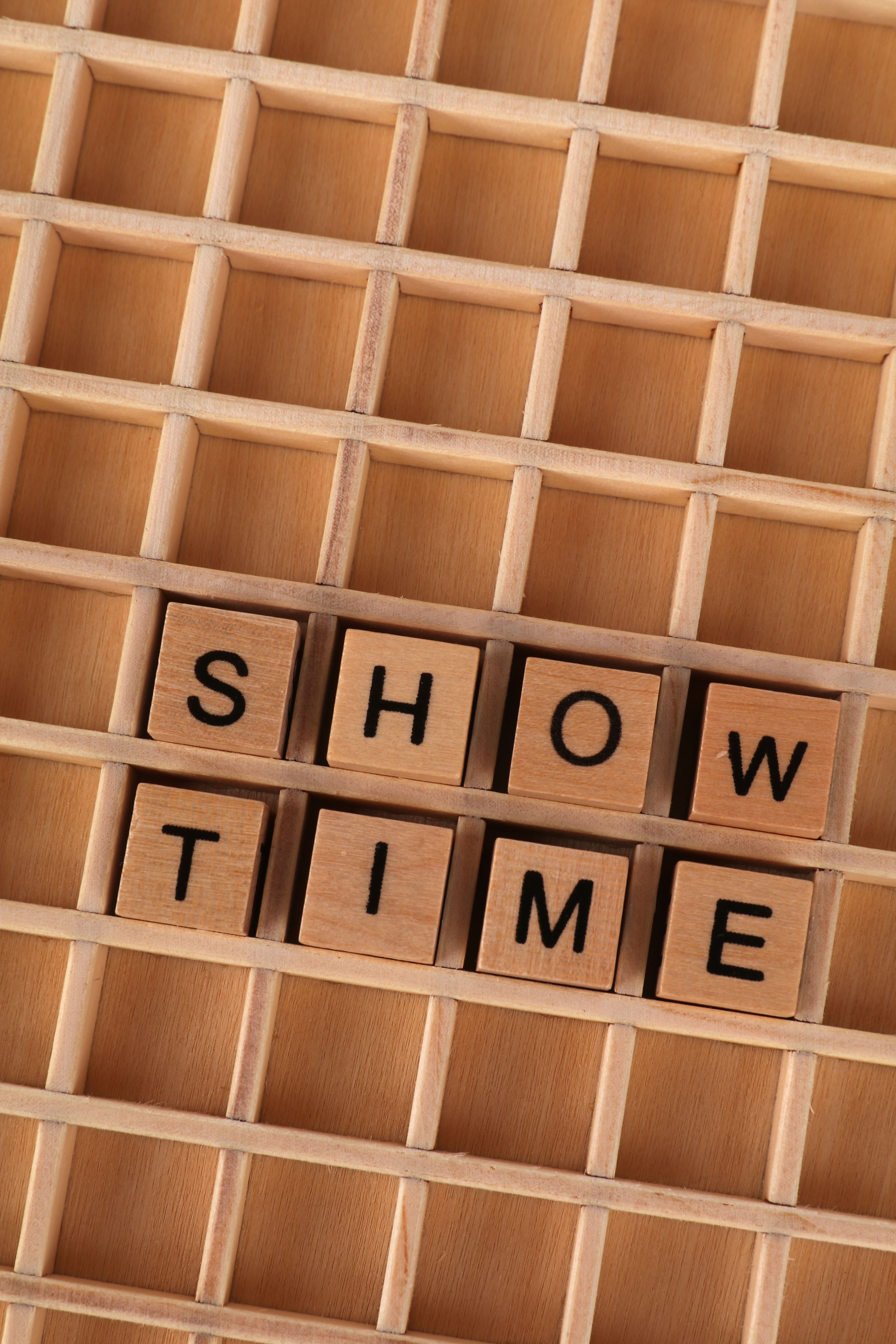 Blocks spelling 'Show Time' on a lattice background. Perfect for entertainment themes.