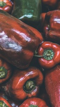 A vibrant close-up of fresh red and green bell peppers, perfect for culinary or market uses.