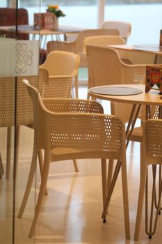 Contemporary cafe chairs and tables in a bright indoor setting.