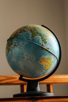 Classic globe displaying continents with a vintage feel on a wooden stand. 3828834