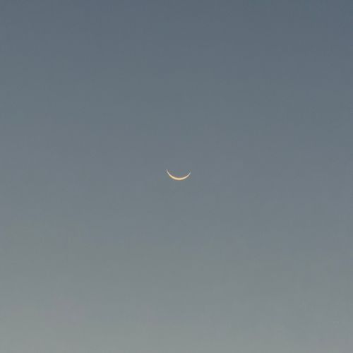 Free A serene twilight sky showcasing a delicate crescent moon in minimalist composition. Stock Photo