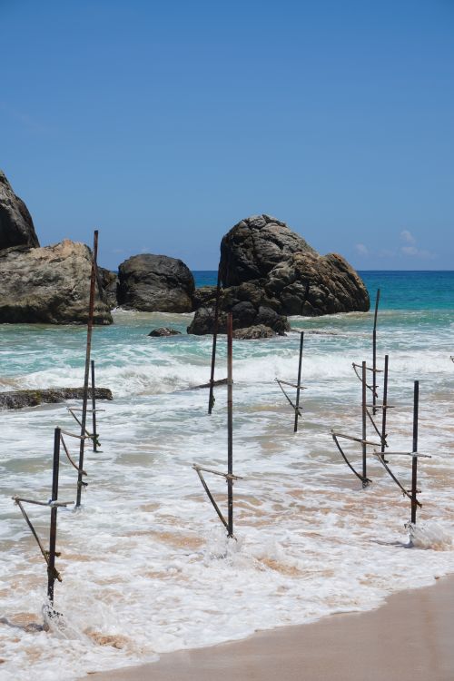 Free Traditional stilt fishing poles on Koggala Beach, a serene coastal scene in Sri Lanka. Stock Photo
