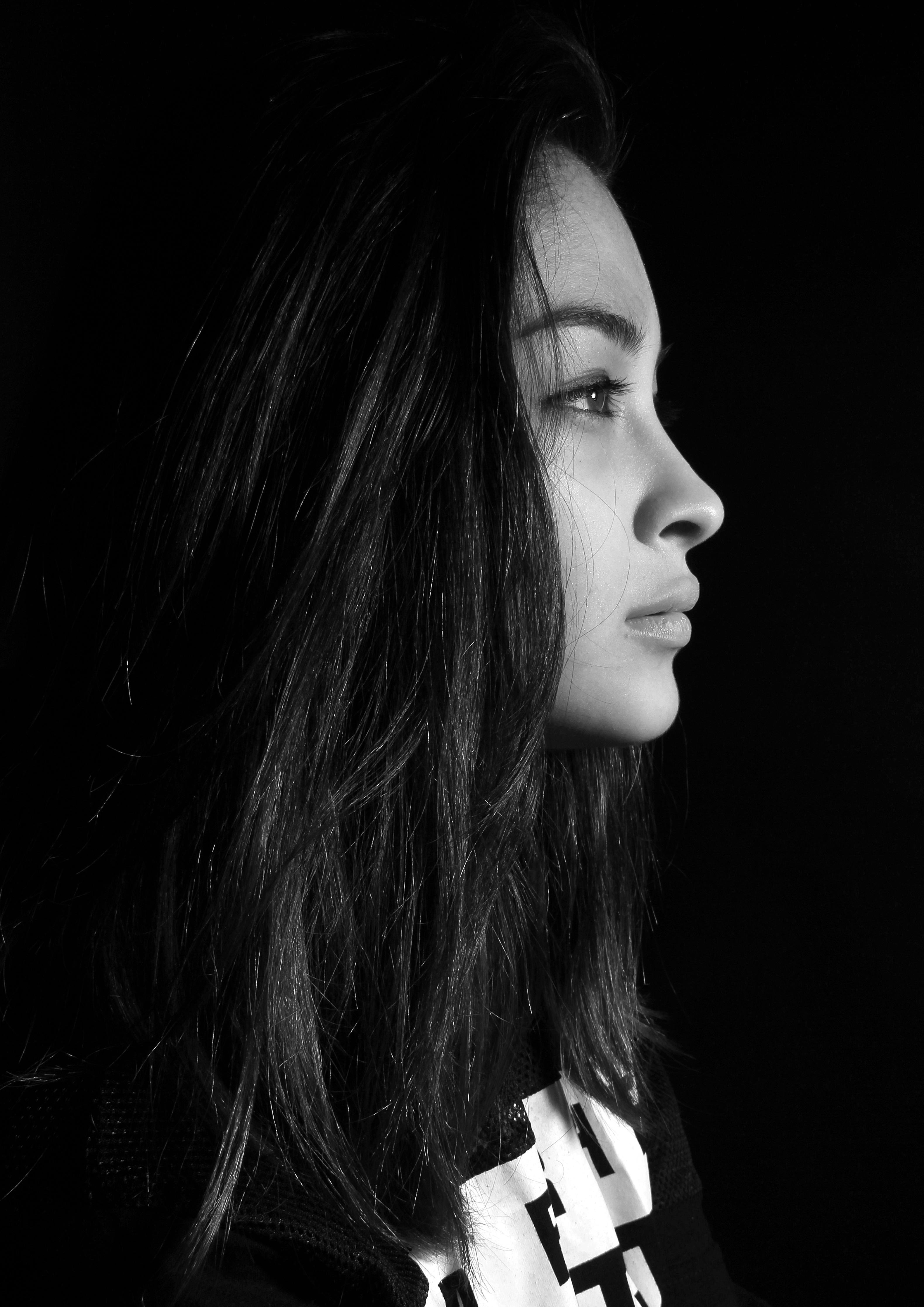 Large Portrait of the Girl`s Profile. Girl`s Face on a Black