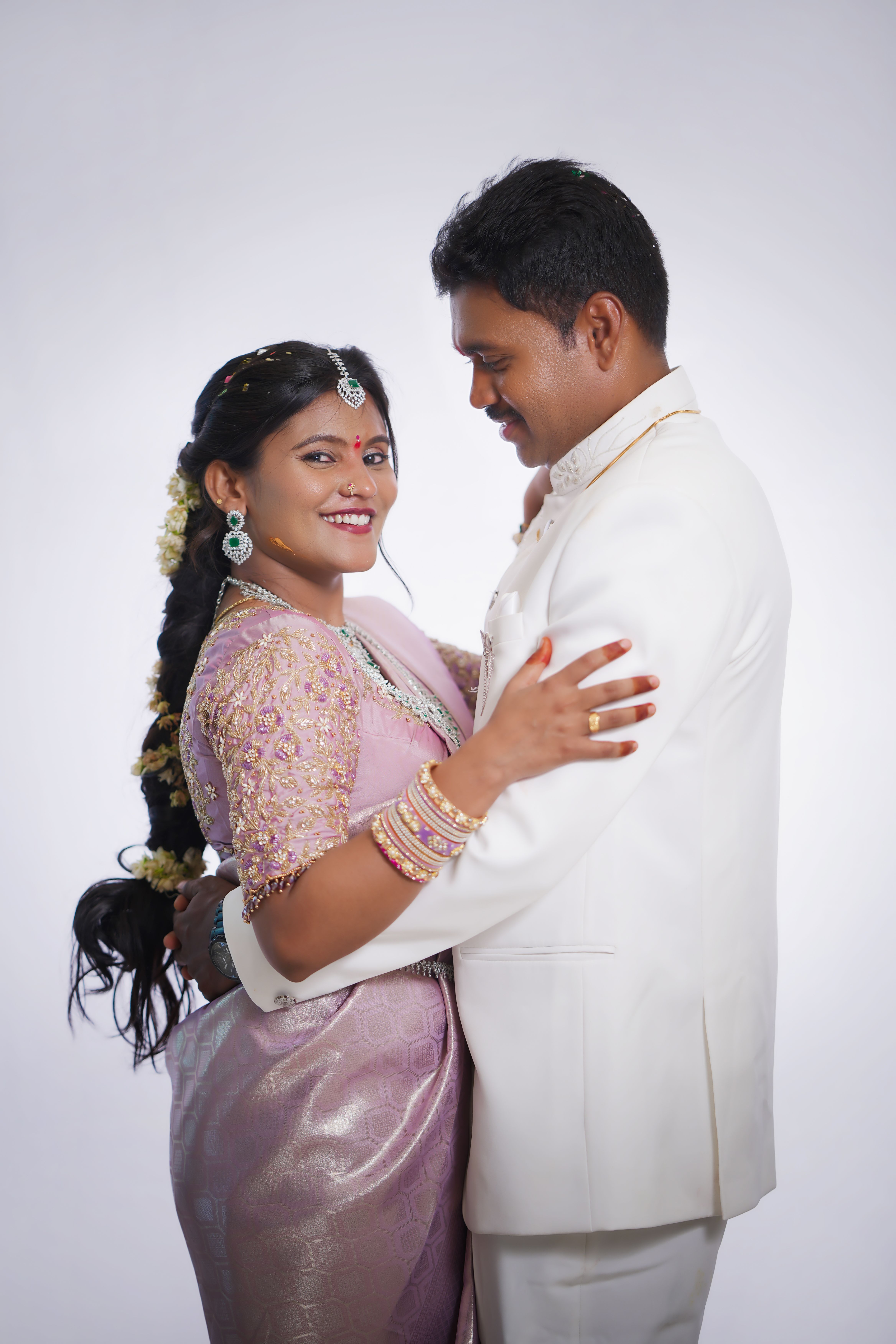 Graceful portrait of a South Indian couple in traditional attire, embracing with joy and elegance.