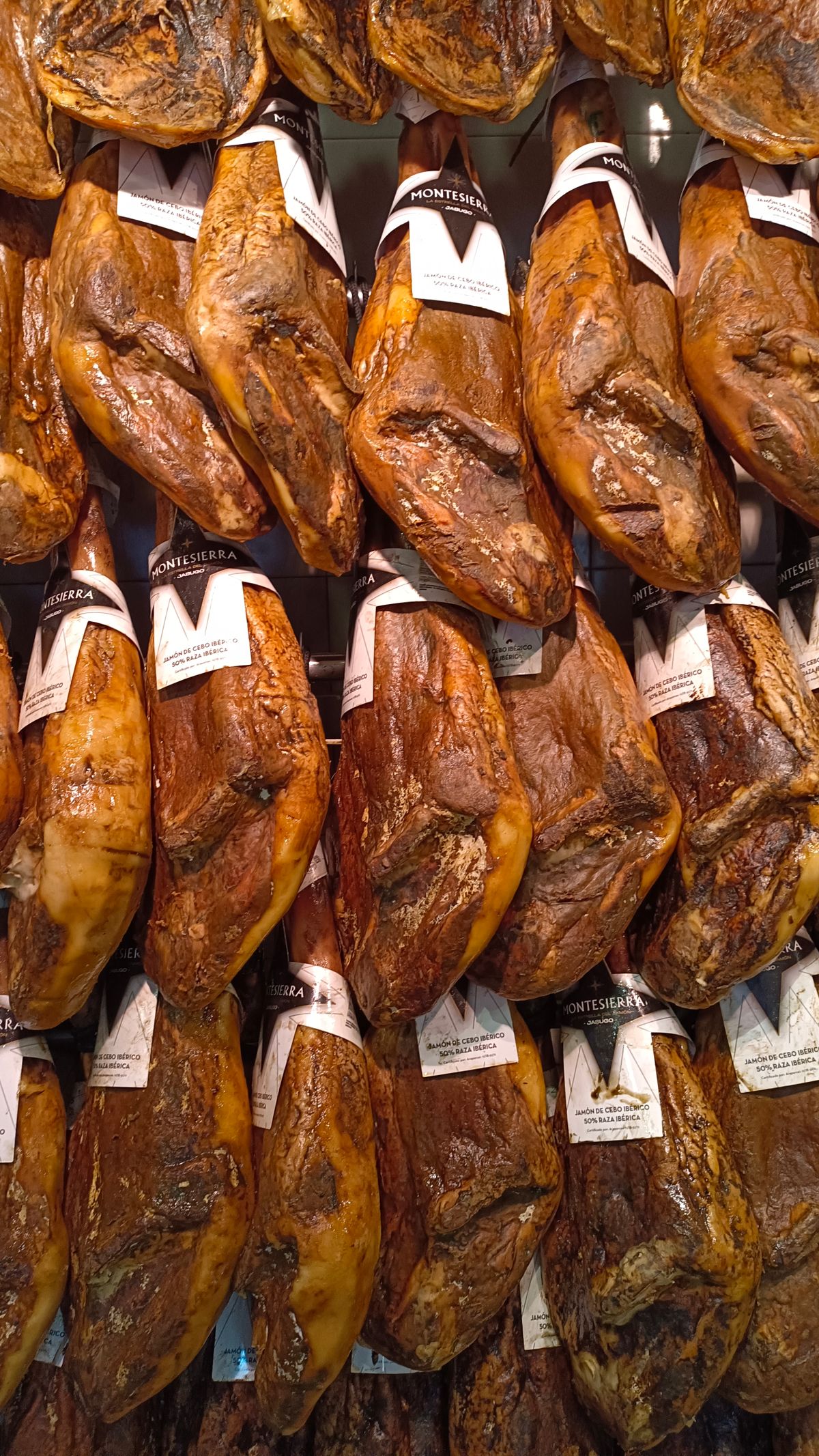 Cured hams hanging in a traditional curing room