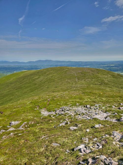 Free Lush green hills and clear skies in Irish countryside offer a stunning panoramic view. Stock Photo