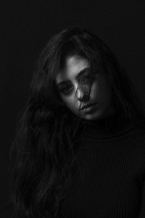Free Artistic black and white portrait capturing a woman's contemplative expression. Stock Photo