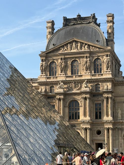 Free Iconic architecture of the Louvre with glass pyramid in Paris, France. Stock Photo