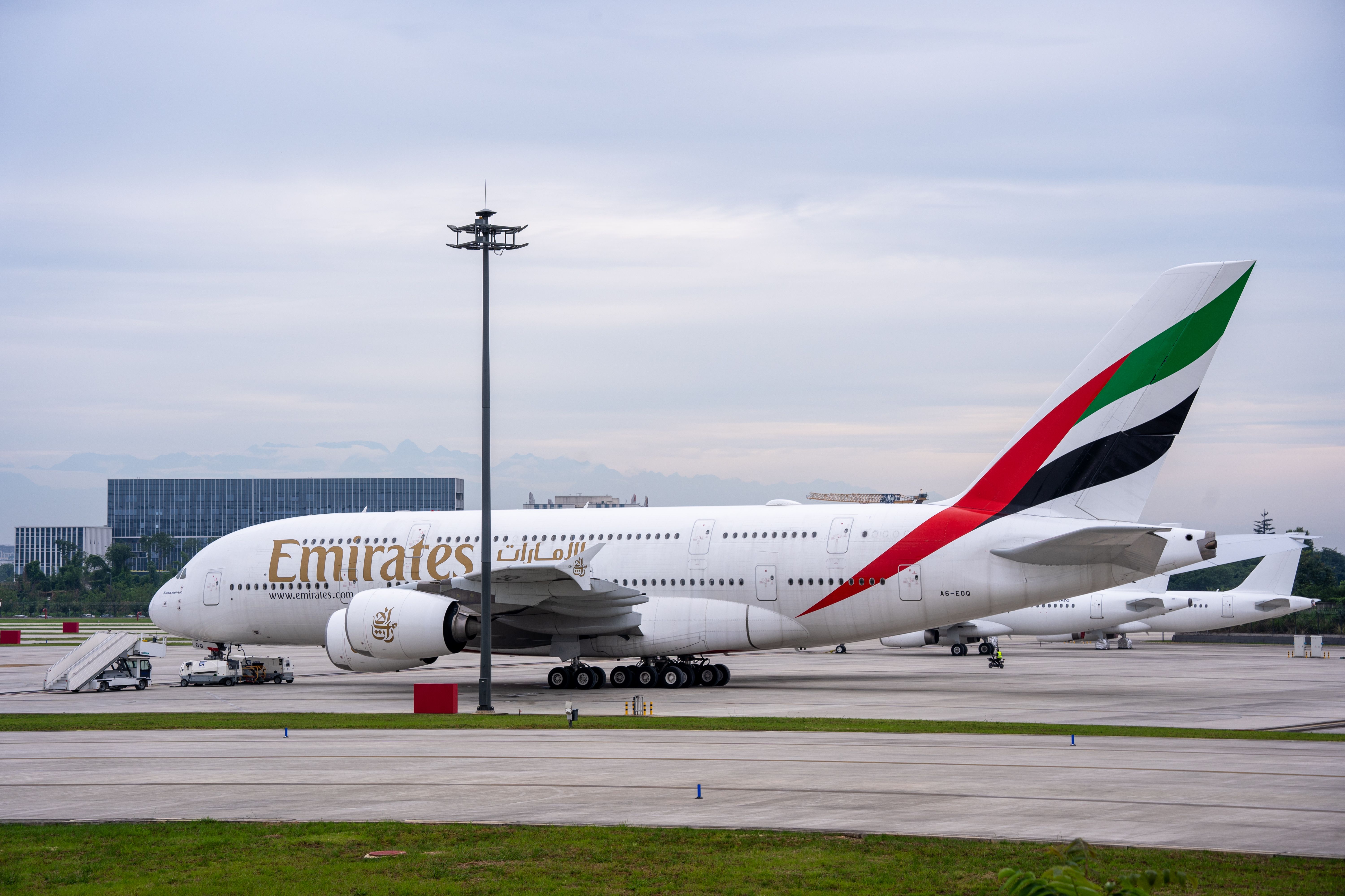 Hotel towers close to an airport terminal with aircraft on the apron