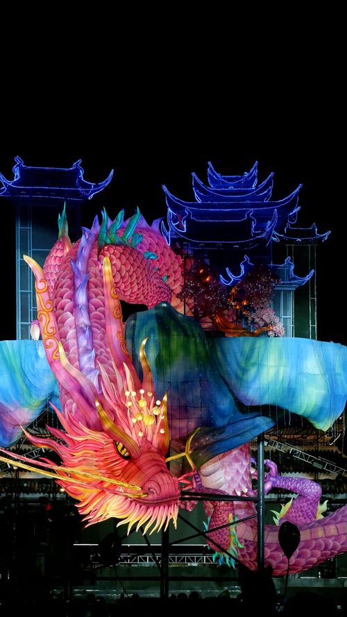 Free Colorful illuminated dragon lantern against traditional architecture, captured at night in Jingzhou, China. Stock Photo