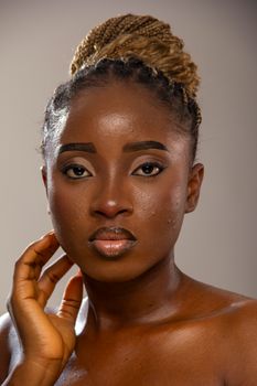 A captivating portrait of a confident woman with braided hair and a graceful expression.