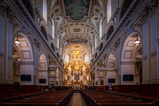 Gorgeous view of a cathedral's ornate interior, showcasing intricate design and stunning gold detailing.