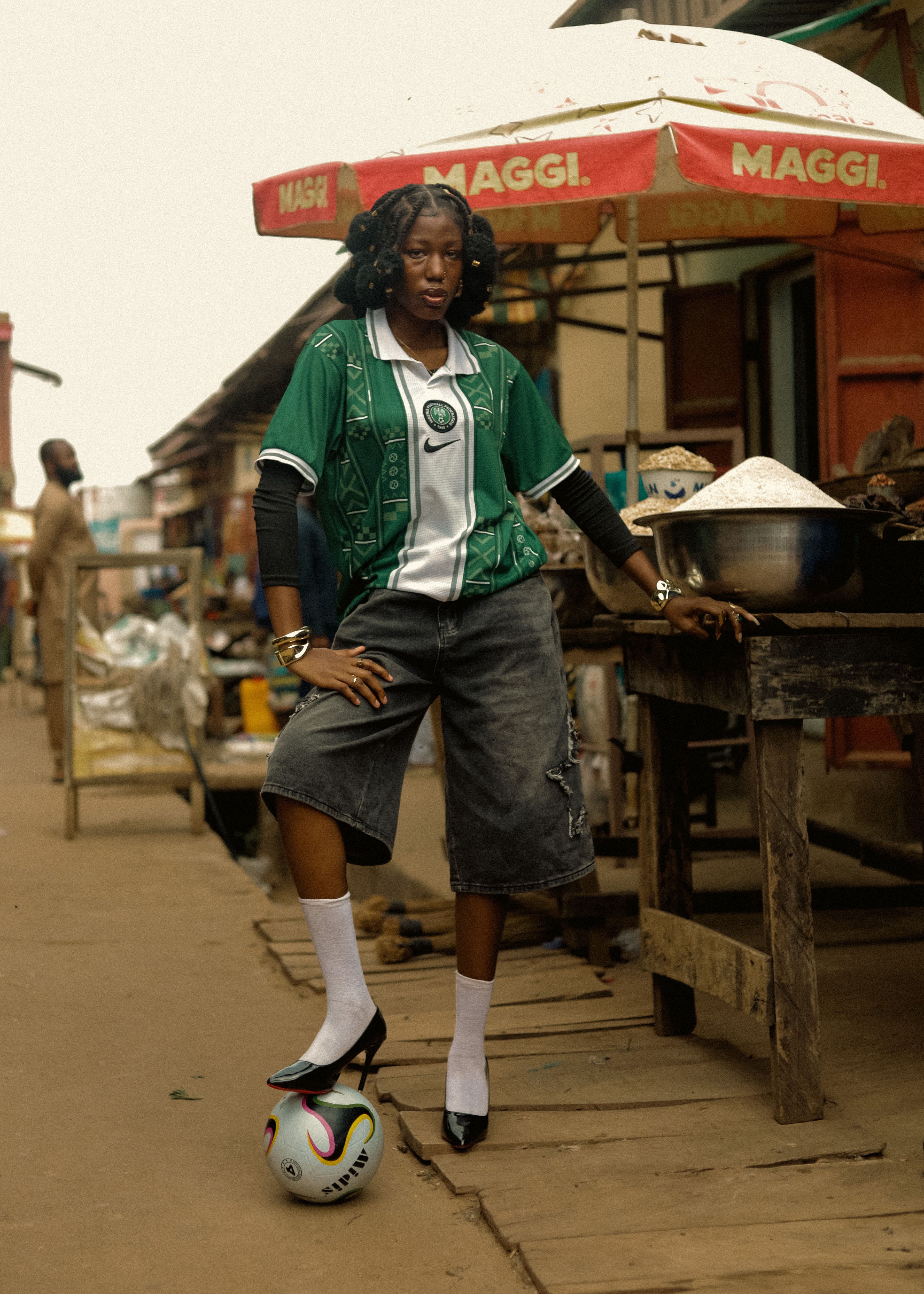 Stylish woman in an urban market street wearing soccer jersey and shorts.