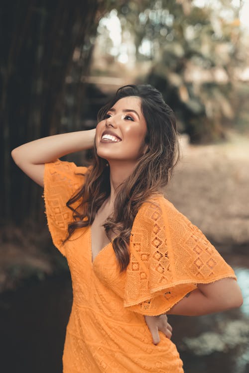 Woman In Orange Dress Smiling