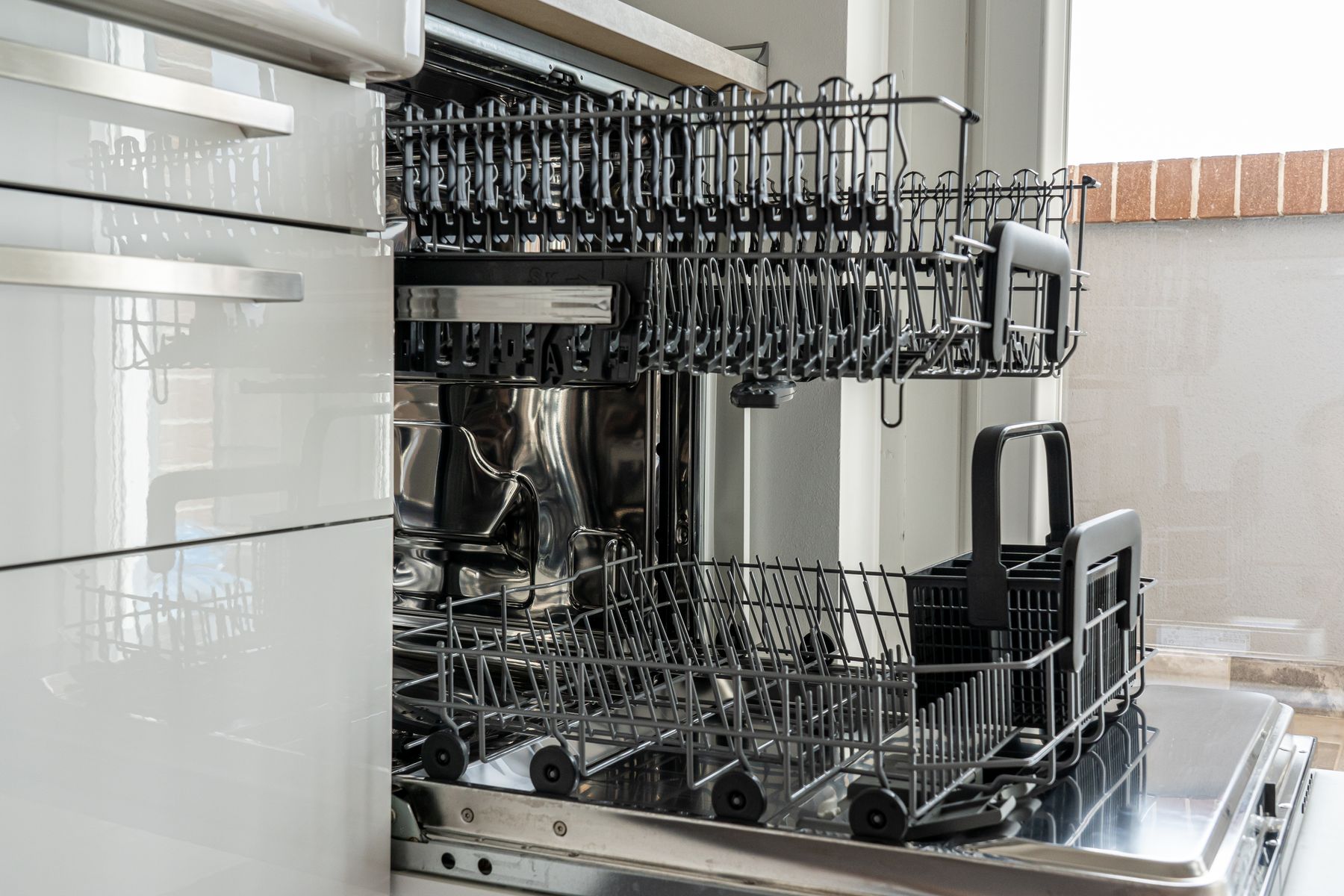 Open dishwasher in modern kitchen for dishwasher repair in Jumeirah Park