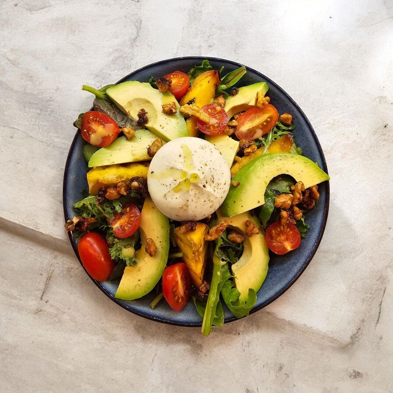 Avocado, tomato and burrata salad on a pale stone counter — Surendra Shrestha on Pexels