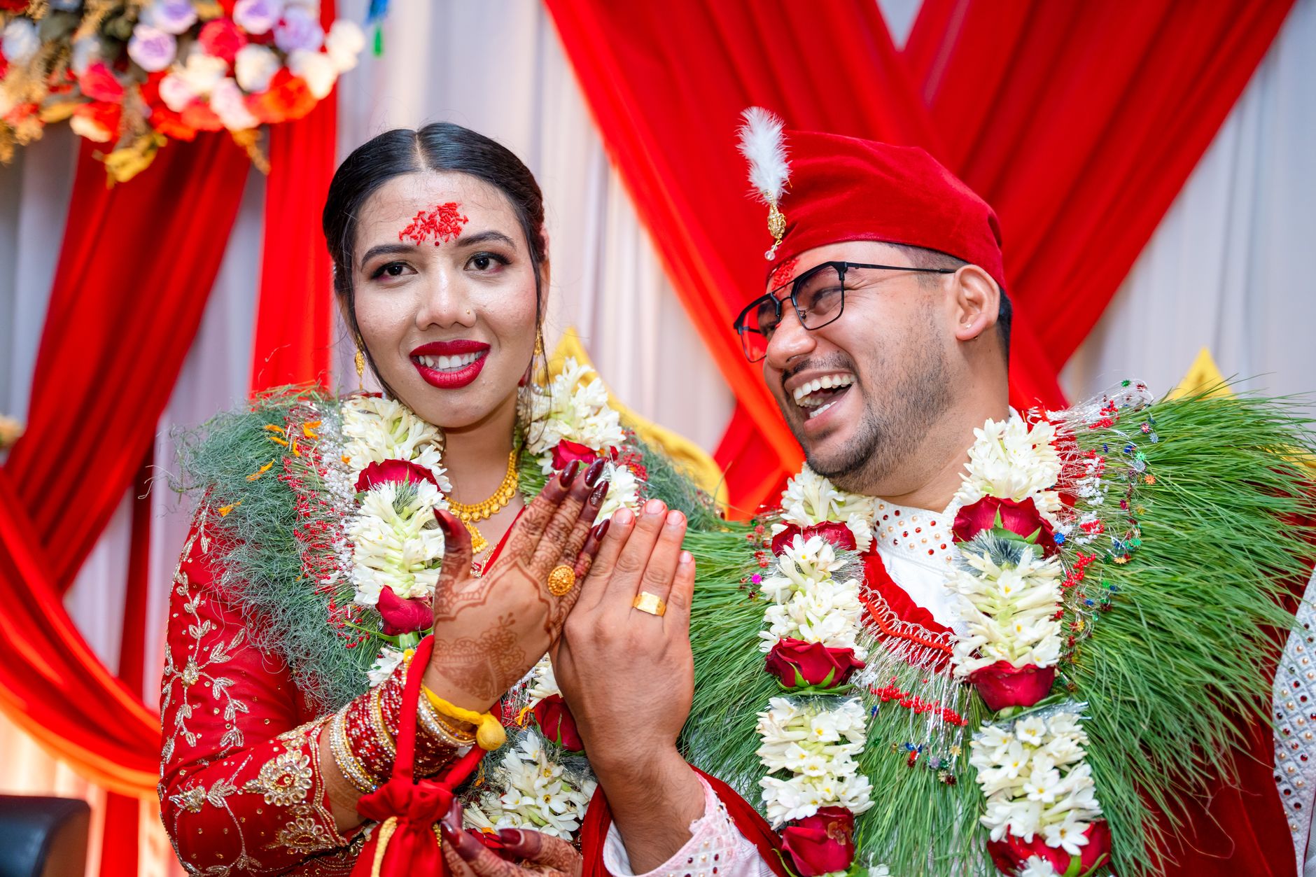 Bride and groom in traditional attire joyfully celebrating their wedding ceremony.