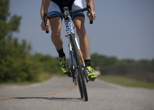 Free Person Riding Road Bike on the Road Stock Photo