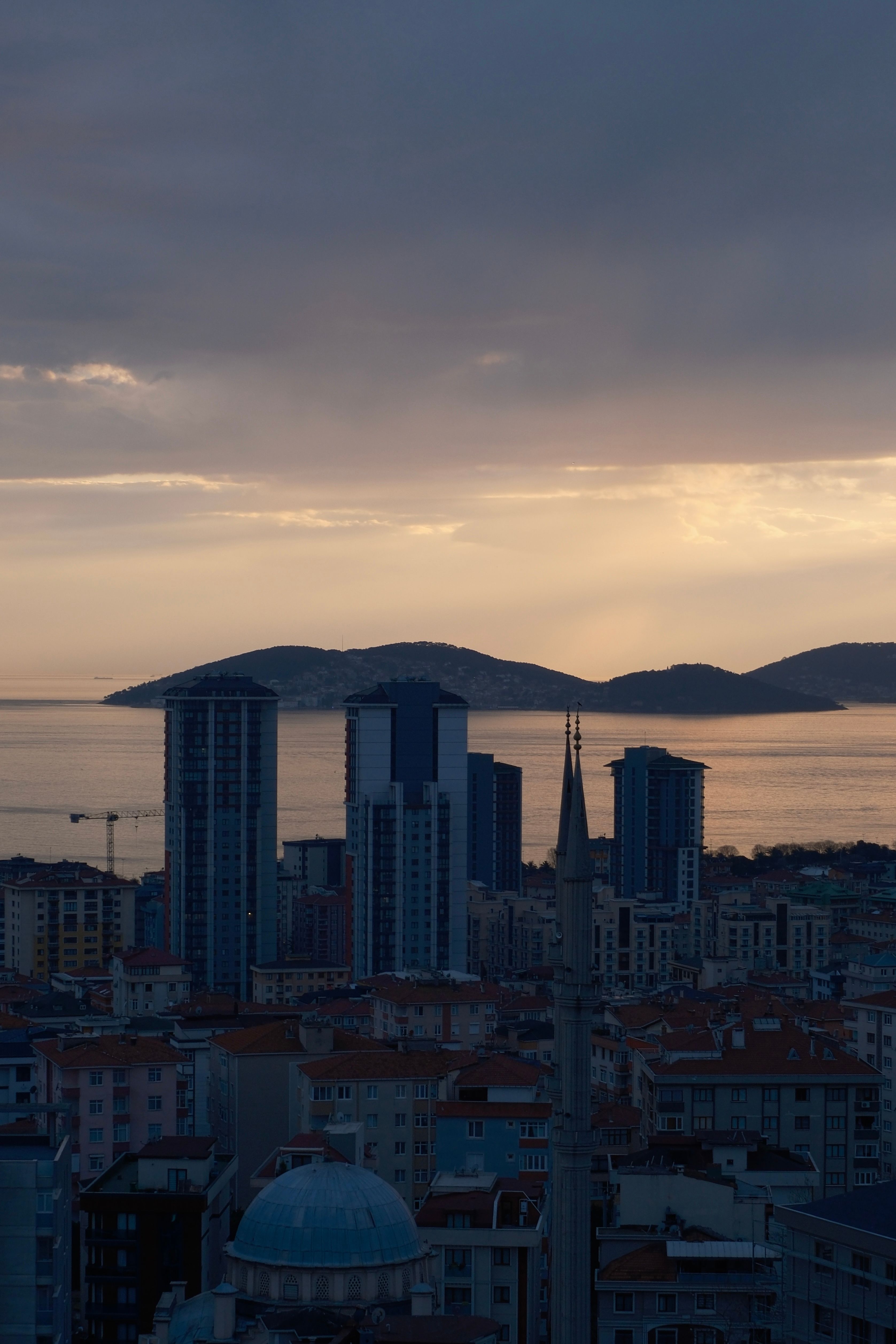 Serene Istanbul cityscape featuring modern buildings and sea at dusk.