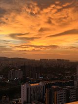 Sunset over the Pune cityscape with vibrant orange skies