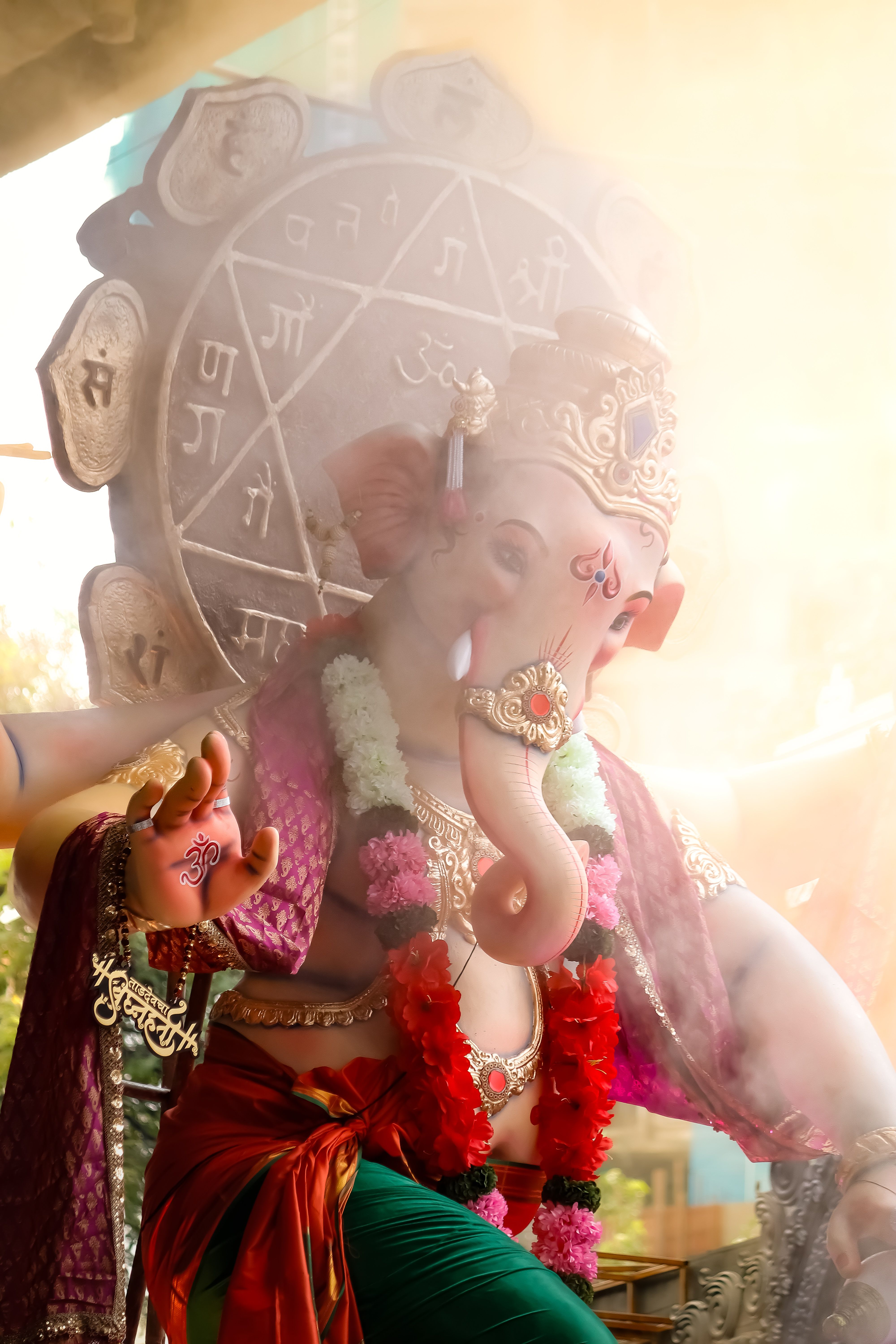 Vibrant Ganesh idol surrounded by spiritual symbols, perfect for festivals and celebrations.
