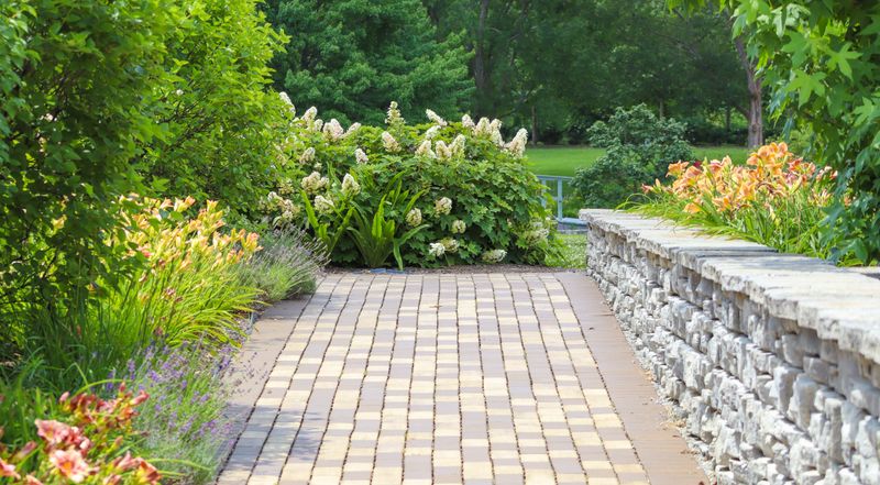 Paver walkway beside a stone wall