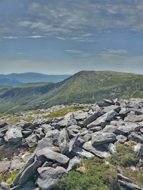 Free Scenic view of rocky terrain and lush mountains in Ireland under a bright sky. Stock Photo