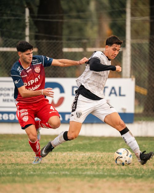 Free Two soccer players competing for the ball during an intense match on the field. Stock Photo