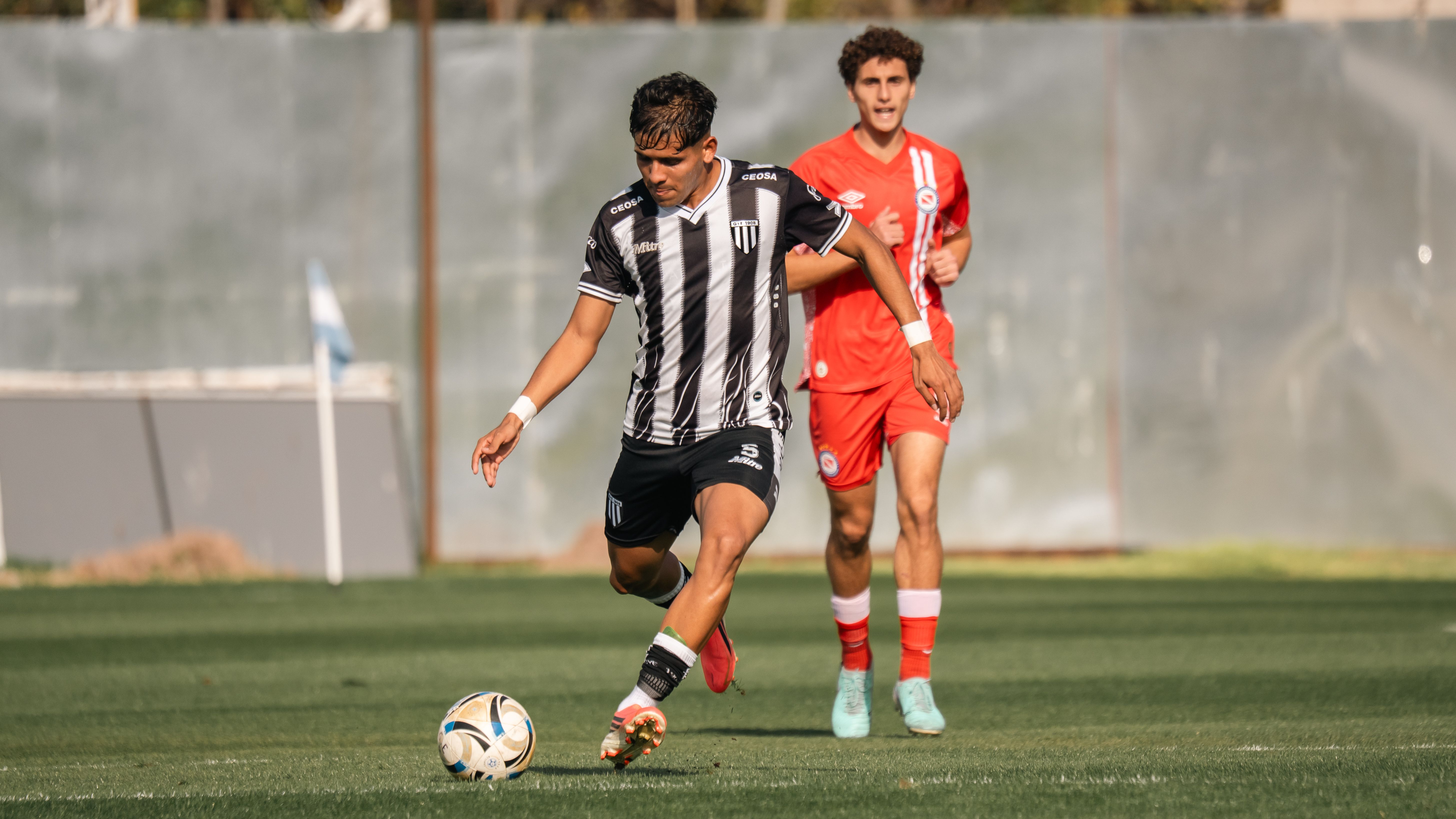 Soccer players in competitive match action · Free Stock Photo