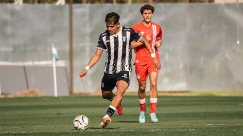 Free Intense soccer match with players in motion on a sunny day. Stock Photo
