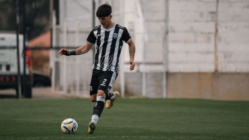 Free A young soccer player in action, dribbling the ball during a game on the field. Stock Photo