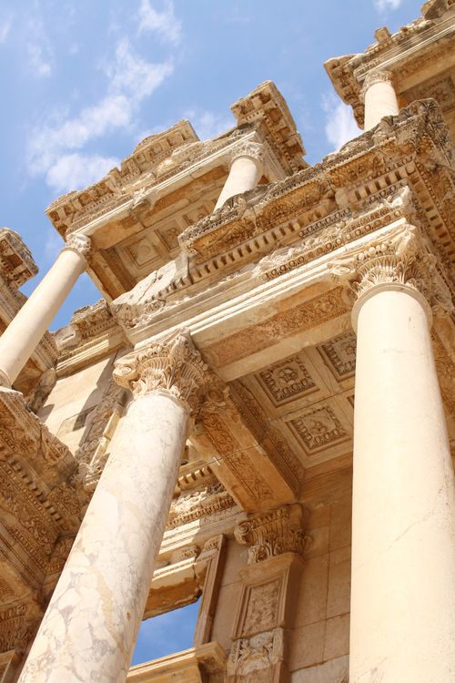 Free View of the grand columns of Ephesus Library under a clear blue sky, showcasing Roman architectural splendor. Stock Photo