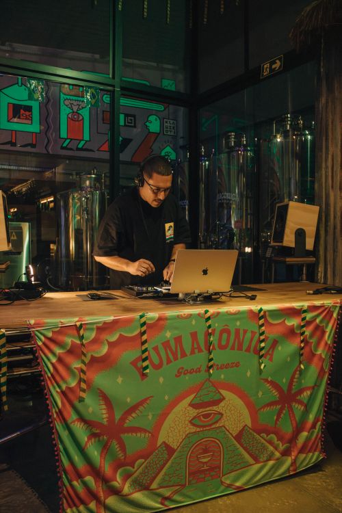 Free DJ mixes music at Fumazonia bar, colorful atmosphere, lively night scene. Stock Photo