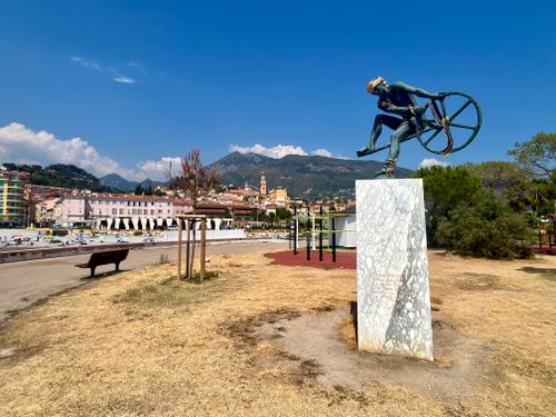 Free Dramatic sculpture in Menton park overlooking the coast under a clear summer sky. Stock Photo