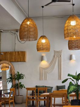 Warm and inviting café interior with wicker lights and wooden furniture in Istanbul.