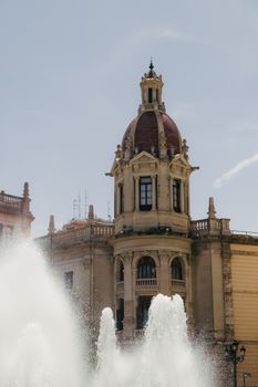 Historic building with ornate architecture in Valencia, captured against a clear sky.