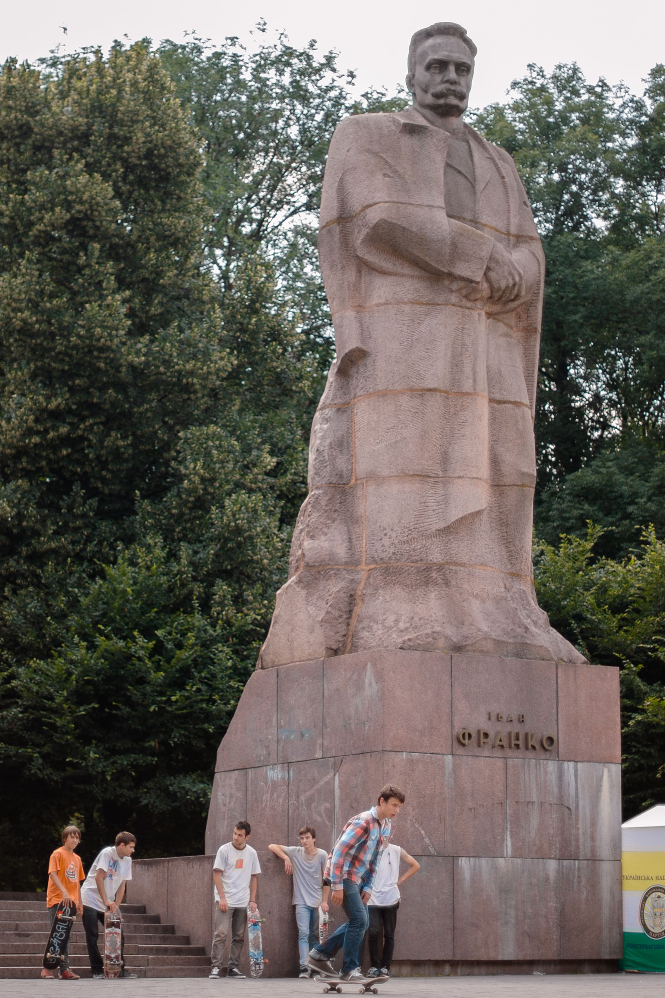 Teenagers skateboarding near Ivan Franko Monument in Lviv, Ukraine.