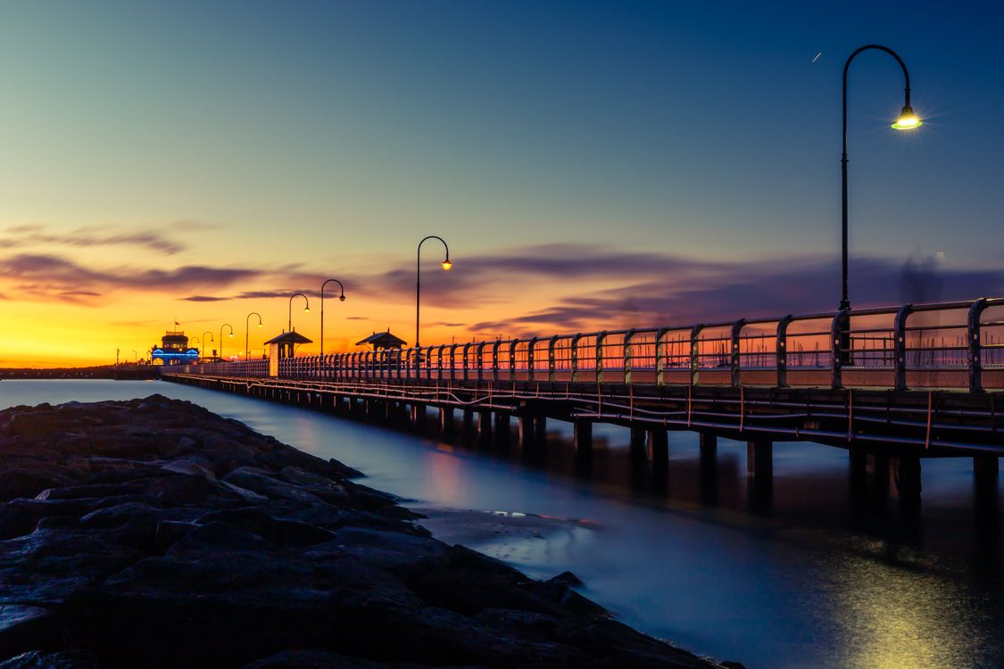 Free Brown Wooden Dock on Body of Water During Sunset Stock Photo