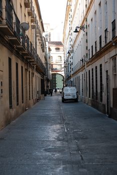 Discover the charm of Seville's narrow streets, capturing urban life and historic architecture.