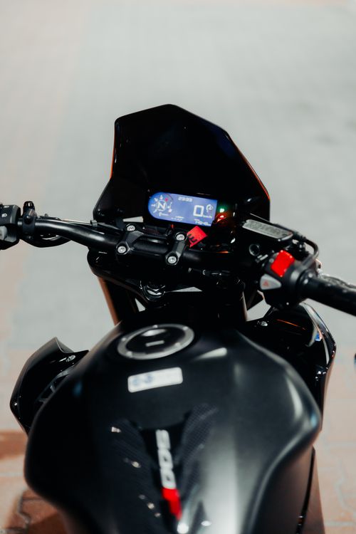 Free A sleek motorcycle dashboard with a digital display captured at night, highlighting modern technology. Stock Photo